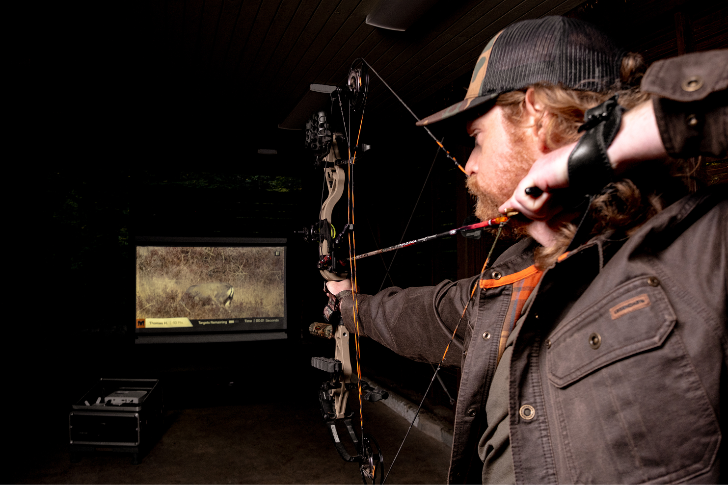 shooting the minum archery simulator in a garage.